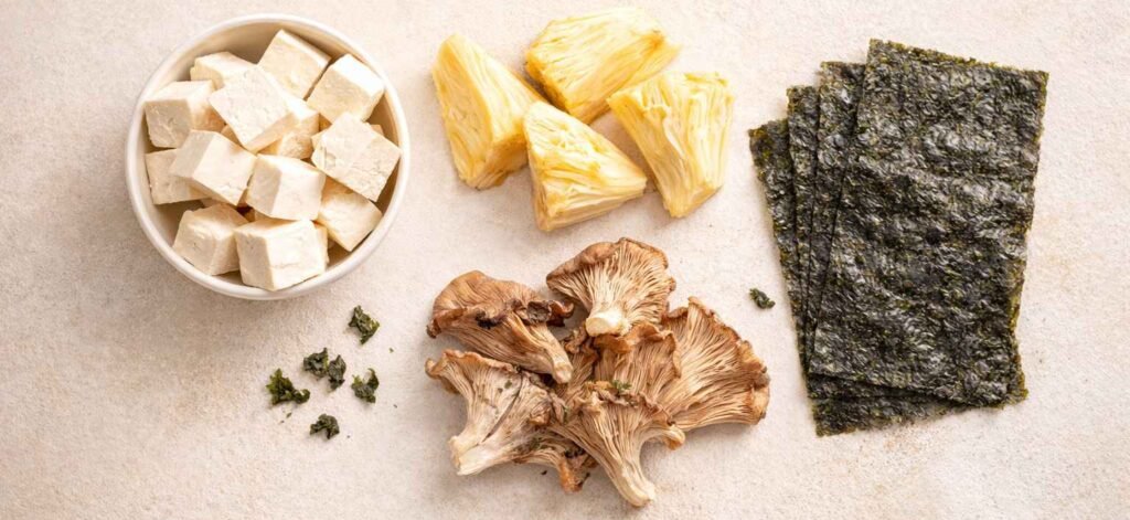 Plant-based ingredients used to make vegan fish including tofu, jackfruit, mushrooms, and seaweed